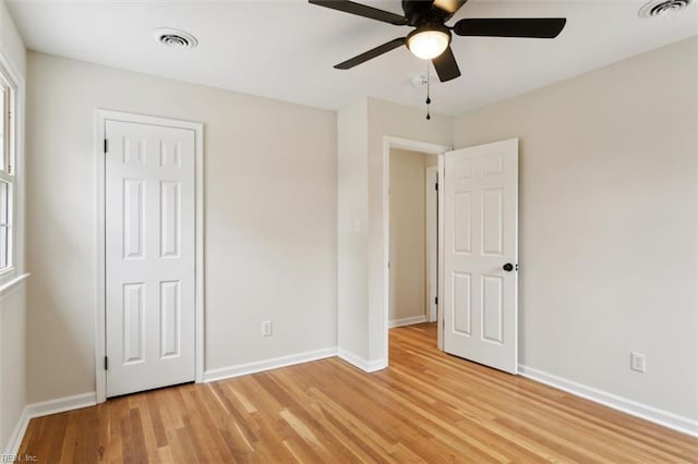 unfurnished bedroom featuring visible vents, baseboards, and light wood-style floors