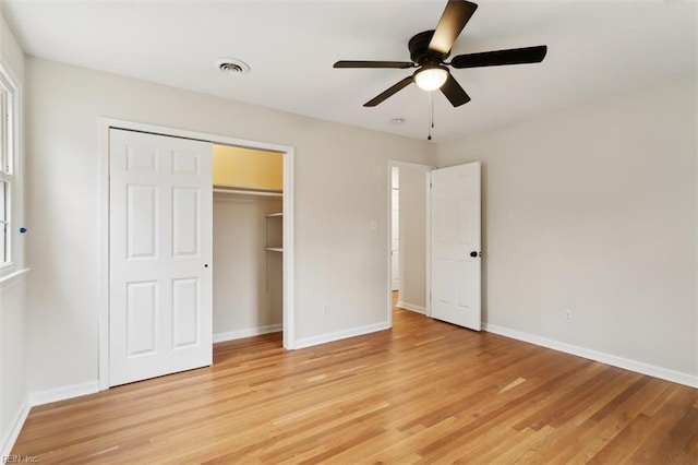 unfurnished bedroom with light wood finished floors, visible vents, and baseboards