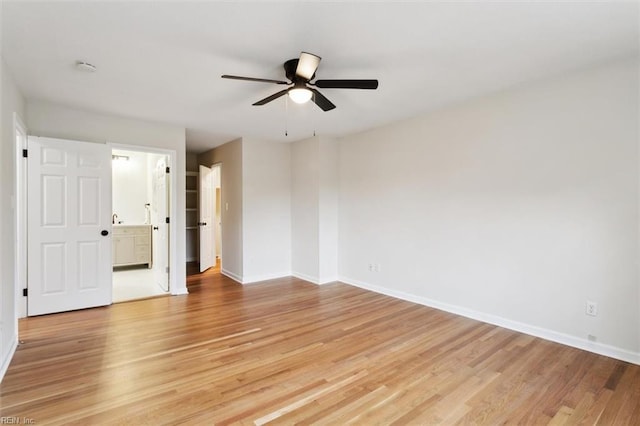 spare room with light wood-style floors, baseboards, and ceiling fan