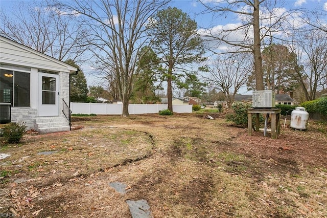 view of yard with entry steps and fence