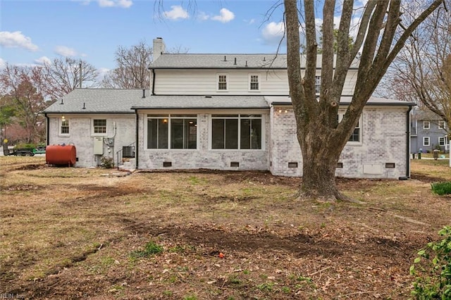 back of property featuring heating fuel, a chimney, roof with shingles, and crawl space