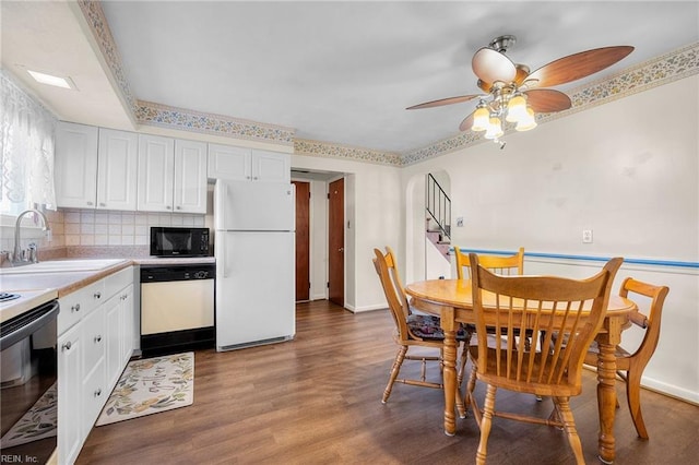 dining area featuring a ceiling fan, wood finished floors, and baseboards