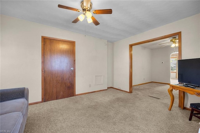 living area featuring baseboards, carpet, and ceiling fan