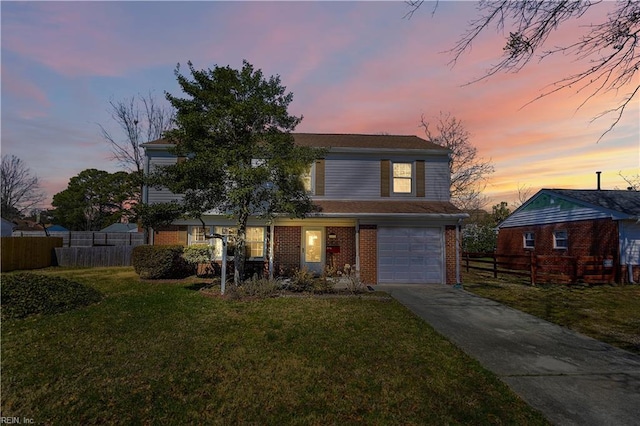 traditional-style home with brick siding, concrete driveway, a front yard, and fence