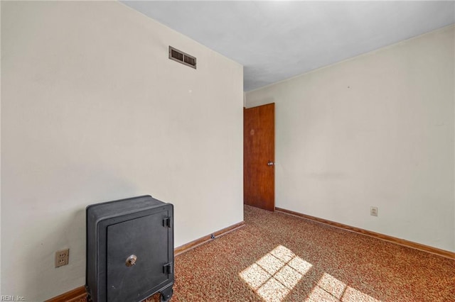 empty room with visible vents, carpet floors, and baseboards