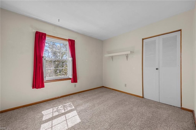 unfurnished bedroom featuring a closet, carpet flooring, and baseboards