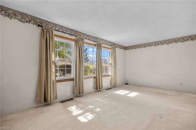 empty room with visible vents and carpet floors