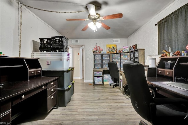 office area with ceiling fan, a textured wall, visible vents, and light wood-type flooring