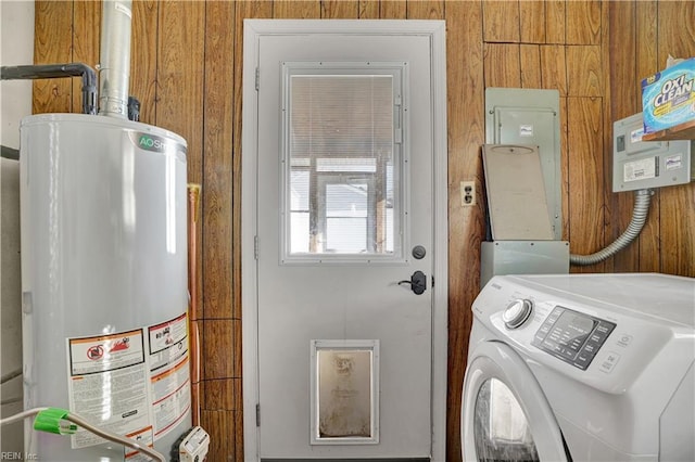 laundry room with washer / clothes dryer, wood walls, water heater, and laundry area