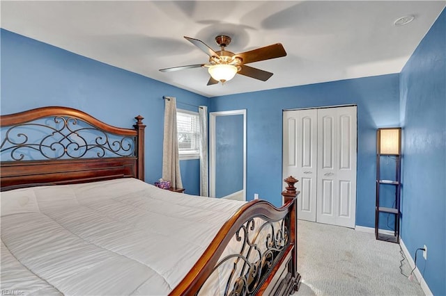 bedroom with a closet, carpet flooring, ceiling fan, and baseboards