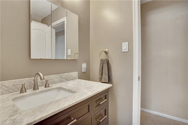 bathroom with baseboards and vanity