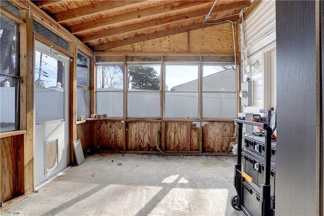 unfurnished sunroom featuring lofted ceiling and plenty of natural light