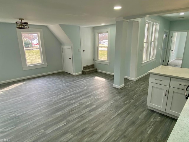 bonus room featuring a wealth of natural light, baseboards, dark wood-type flooring, and recessed lighting