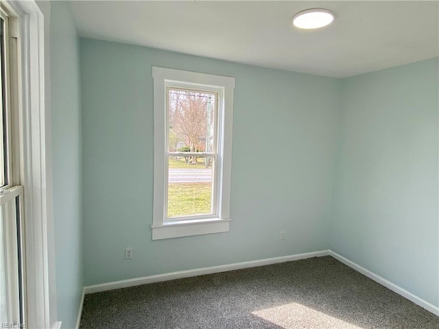 carpeted spare room with baseboards