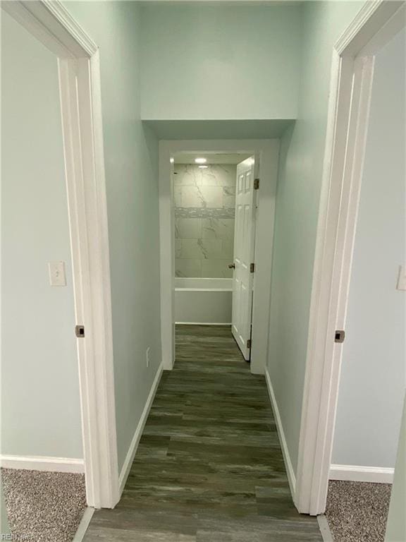 corridor with baseboards and dark wood-style flooring