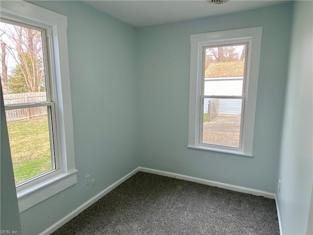 carpeted empty room with baseboards