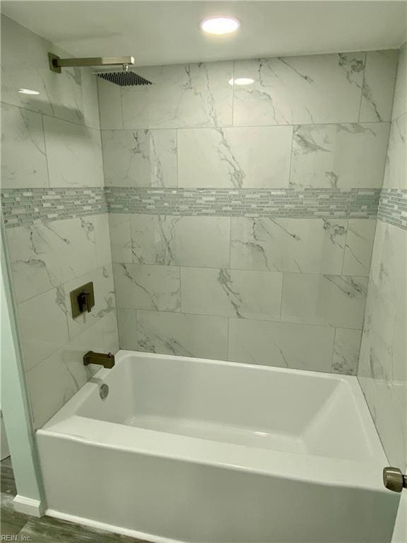 bathroom with shower / tub combination and wood finished floors