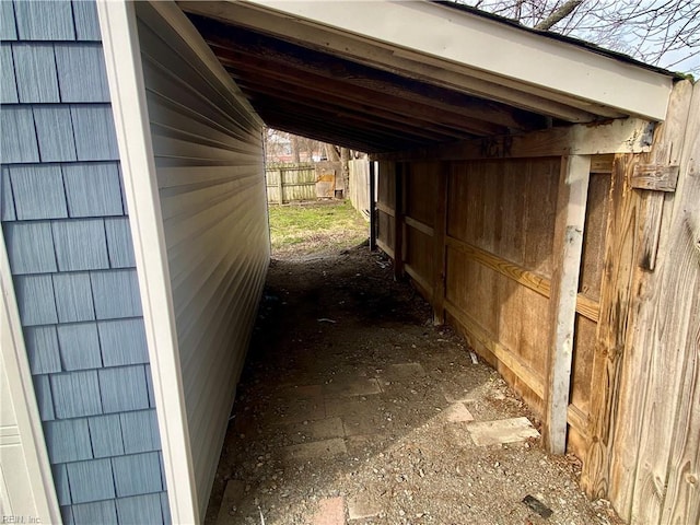 view of property exterior with a carport and fence