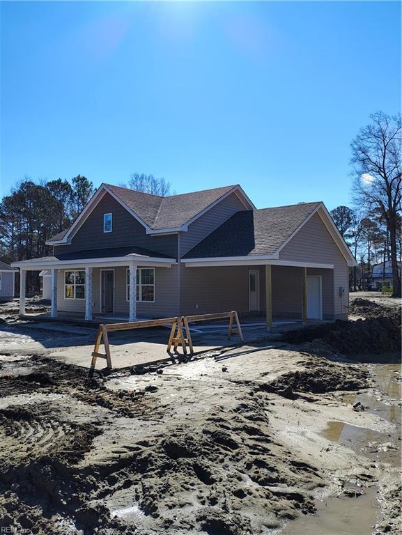 view of front facade with roof with shingles