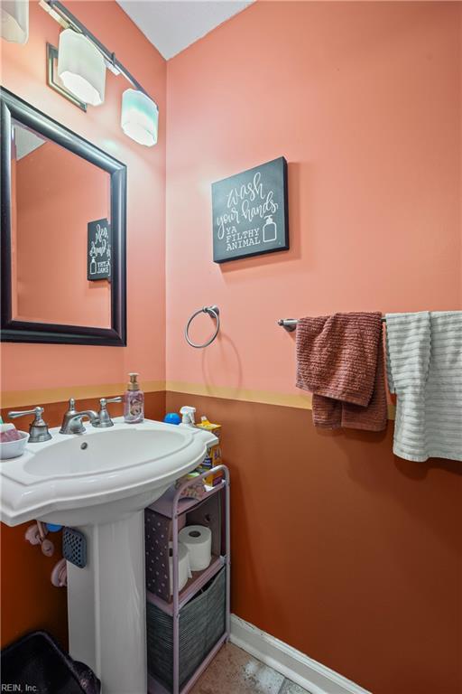 bathroom with baseboards and a sink