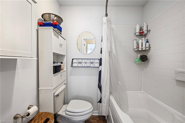 bathroom with toilet and shower / bath combo with shower curtain