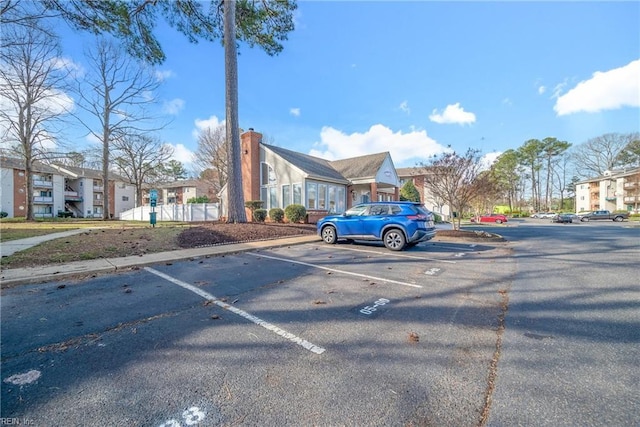 uncovered parking lot featuring a residential view