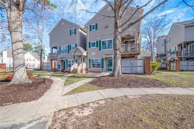 townhome / multi-family property featuring a residential view and a balcony