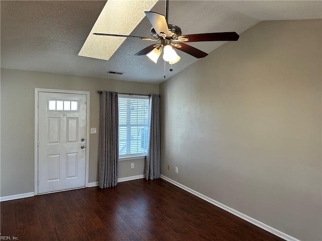 entryway featuring visible vents, baseboards, lofted ceiling, wood finished floors, and a ceiling fan