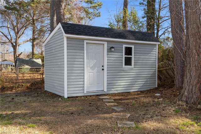 view of shed featuring fence