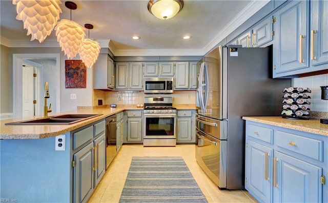 kitchen featuring ornamental molding, a sink, backsplash, appliances with stainless steel finishes, and a peninsula