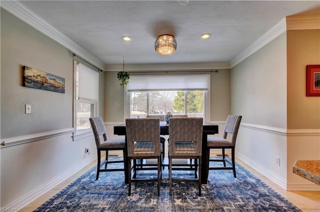 tiled dining area featuring baseboards and ornamental molding