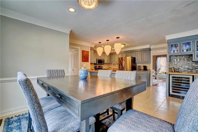 dining space featuring wine cooler, light tile patterned floors, bar, and crown molding