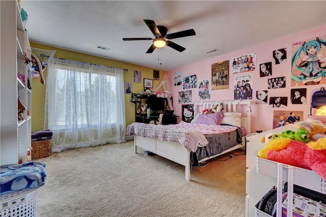 carpeted bedroom with visible vents and a ceiling fan