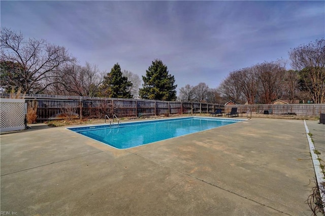 view of swimming pool featuring a fenced in pool, a fenced backyard, and a patio area