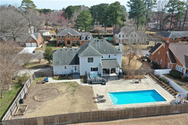 exterior space with a residential view, a fenced in pool, a patio, and a fenced backyard