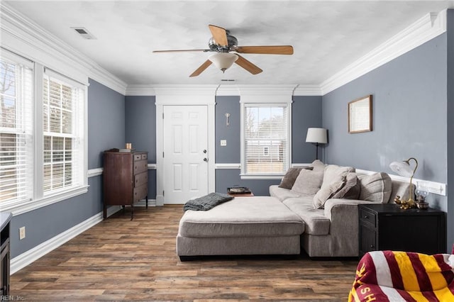 living area featuring dark wood-style floors, a ceiling fan, baseboards, and ornamental molding