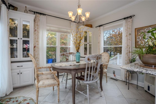 dining space featuring light tile patterned floors, visible vents, baseboards, crown molding, and a chandelier