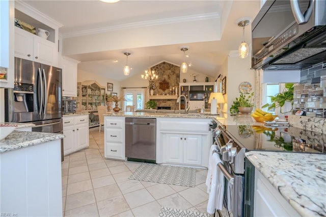 kitchen featuring ornamental molding, a sink, stainless steel appliances, white cabinets, and vaulted ceiling