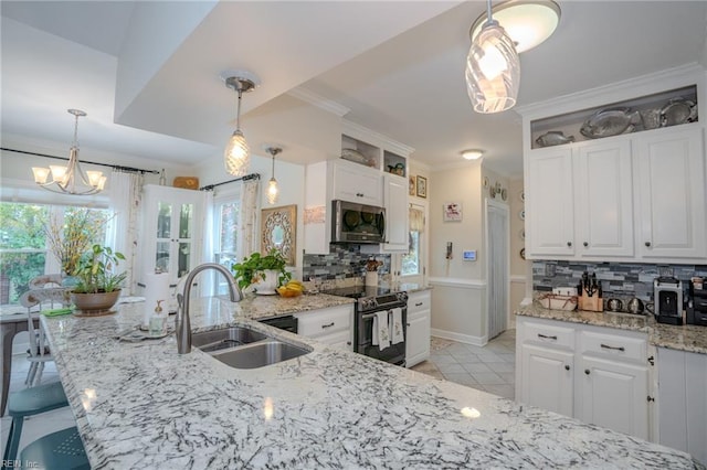 kitchen featuring a sink, backsplash, white cabinetry, appliances with stainless steel finishes, and crown molding