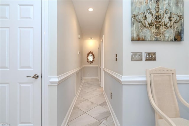 corridor with recessed lighting, baseboards, and marble finish floor