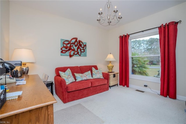 carpeted living room featuring a notable chandelier, baseboards, and visible vents