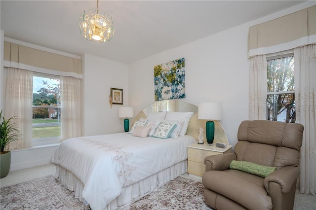 bedroom featuring multiple windows, carpet, and a chandelier