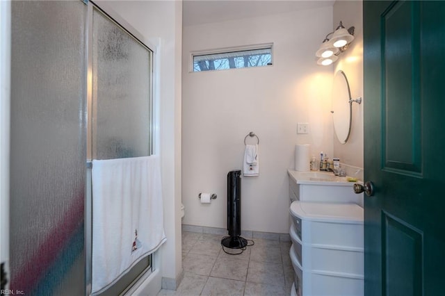 full bathroom with a shower stall, baseboards, toilet, tile patterned floors, and vanity