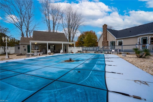 view of swimming pool with a fenced in pool, a patio, and fence