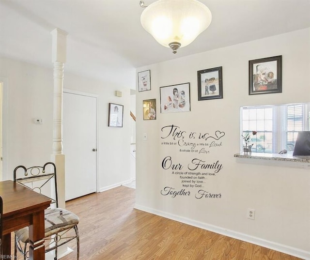 dining area featuring light wood finished floors and baseboards