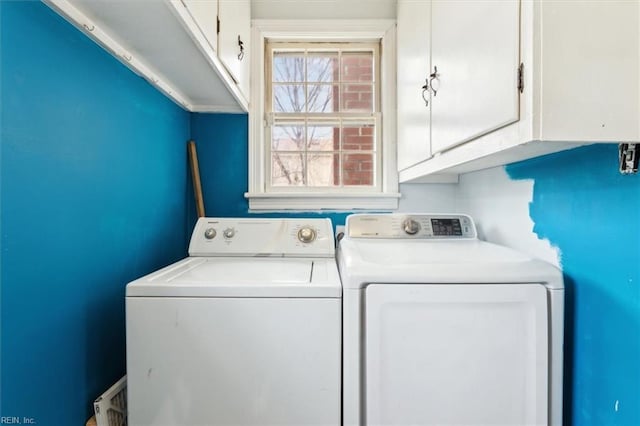 laundry area featuring washer and dryer and cabinet space