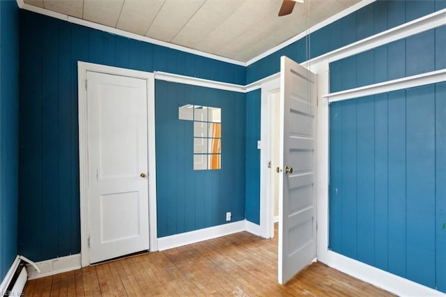 entryway with hardwood / wood-style floors, ceiling fan, baseboards, and a baseboard radiator