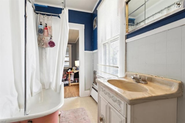 full bath with vanity, crown molding, a shower with curtain, and a baseboard radiator