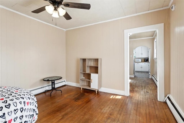 bedroom featuring baseboard heating, crown molding, and a baseboard radiator