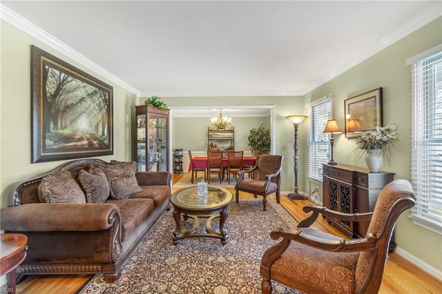 living area featuring plenty of natural light, crown molding, and wood finished floors